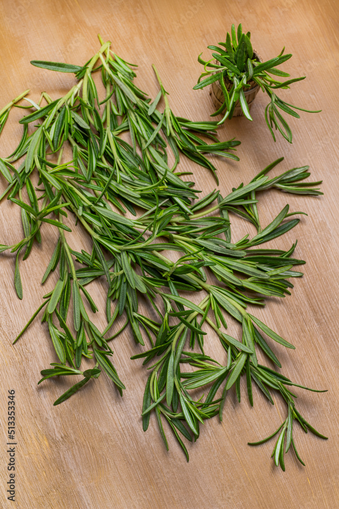 Sprigs of green rosemary on brown background Sprigs of green rosemary on brown background