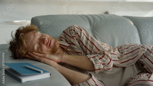 Bilde på lerret Relaxed guy sleeping sofa in pajamas closeup