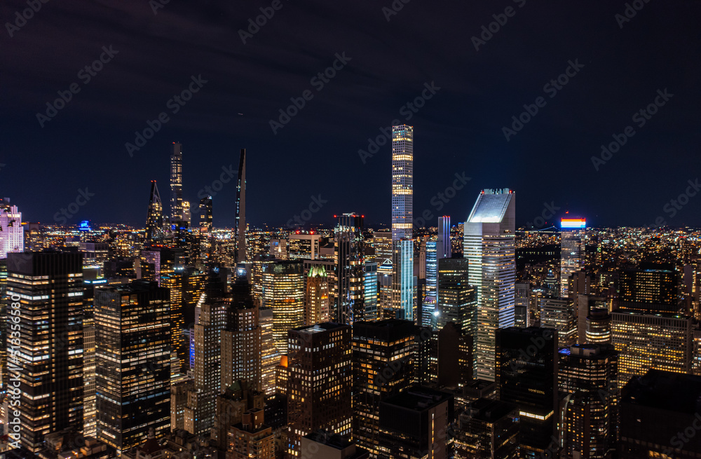 Panoramic aerial view of group of skyscraper near central park. Modern high rise buildings in night city. Manhattan, New York City, USA