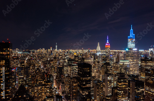 Colourful spikes on top of famous skyscrapers, Chrysler, Empire state and One Vanderbilt. Amazing night city scene. Manhattan, New York City, USA