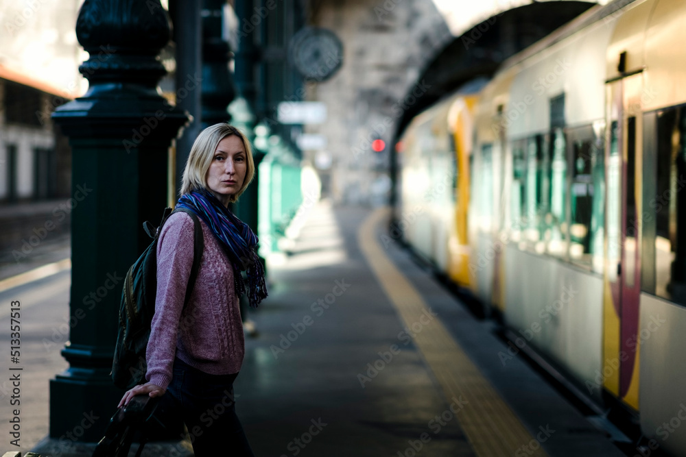 A woman on the platform waiting for a train.