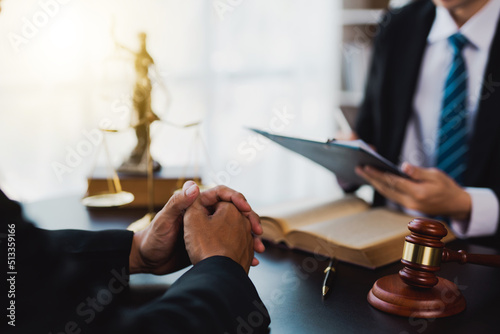 male lawyer discuss to a legal document explaining the terms of a consultation with a businessman. before signing a contract with a law firm. photo