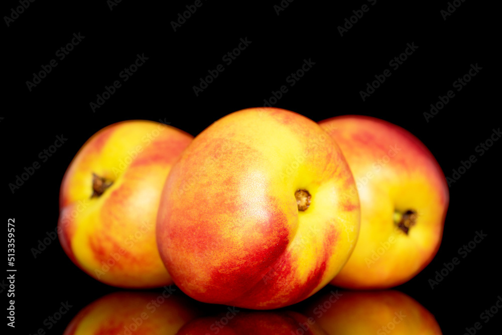 Three sweet organic nectarines, close-up isolated on a black background. Three sweet organic nectarines, close-up isolated on a black background.