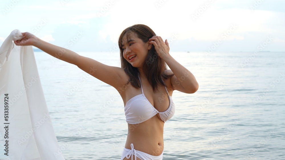 Smiling Young asian woman bikini sexy with shawl on a seaside beach tropical resting and relaxation travel lifestyle, Happy female freedom on summer vacation time on weekend.
