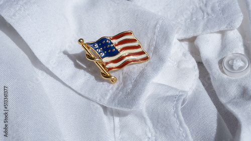Tableau sur toile US flag metal badge on the lapel of a white shirt