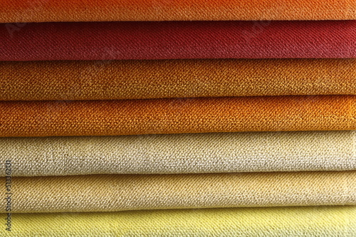 Collection of colorful upholstery fabric samples. Close up. Multicolor fabric texture background.