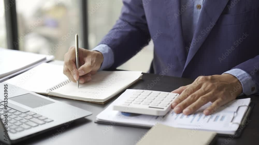 Financial inspector calculating a numbers in office room. business and investment concept. Financial inspector calculating a numbers in office room. business and investment concept.