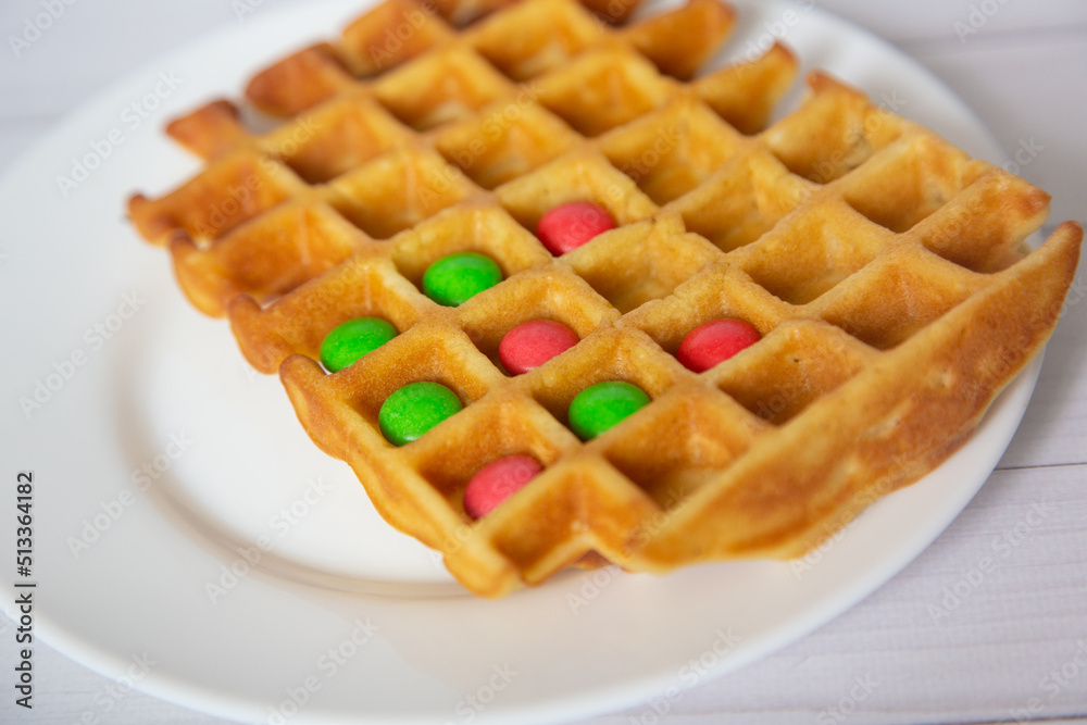 Front view on homemade waffles with chocolate buttons inside. Celective focus Front view on homemade waffles with chocolate buttons inside. Celective focus