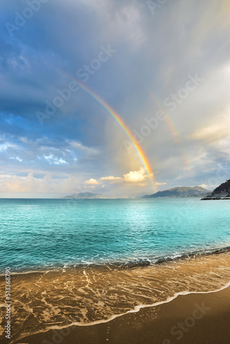 Spectacular rainbow behind a crystal clear sea