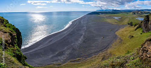 Gorgeous landscape with unique basalt arch on Dyrholaey Endless Beach Nature Reserve on Atlantic South Coast..Location: Dyrholaey cape, Vik I Myrdal village, Katla Geopark, Iceland, Europe photo