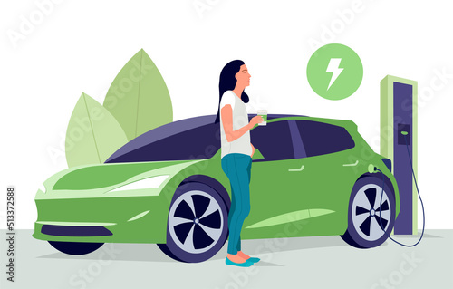 Woman with coffee. Electric car on charging station with green city street skyline. Battery EV vehicle plugged and getting electricity from renewable power generations. Vehicle being charged.