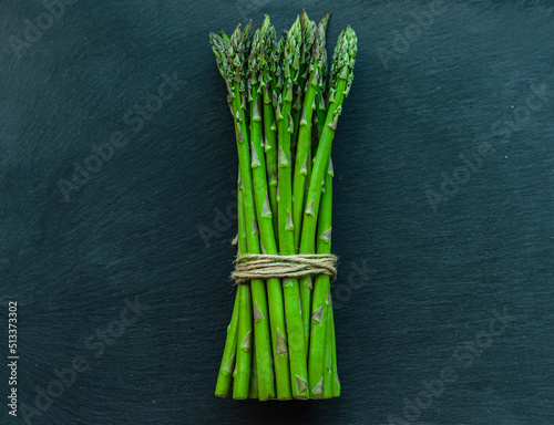 asparagus Green  juicy  fresh  on a black background  space for text  seasonal vegetables  vegetarian products  healthy eating  diet  ingredients for cooking  top view  layout