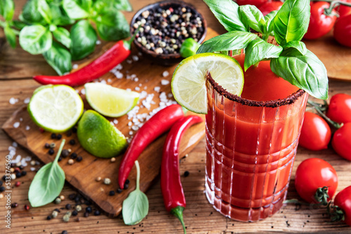 Drink Bloody Mary with peppers, lime and tomatoes