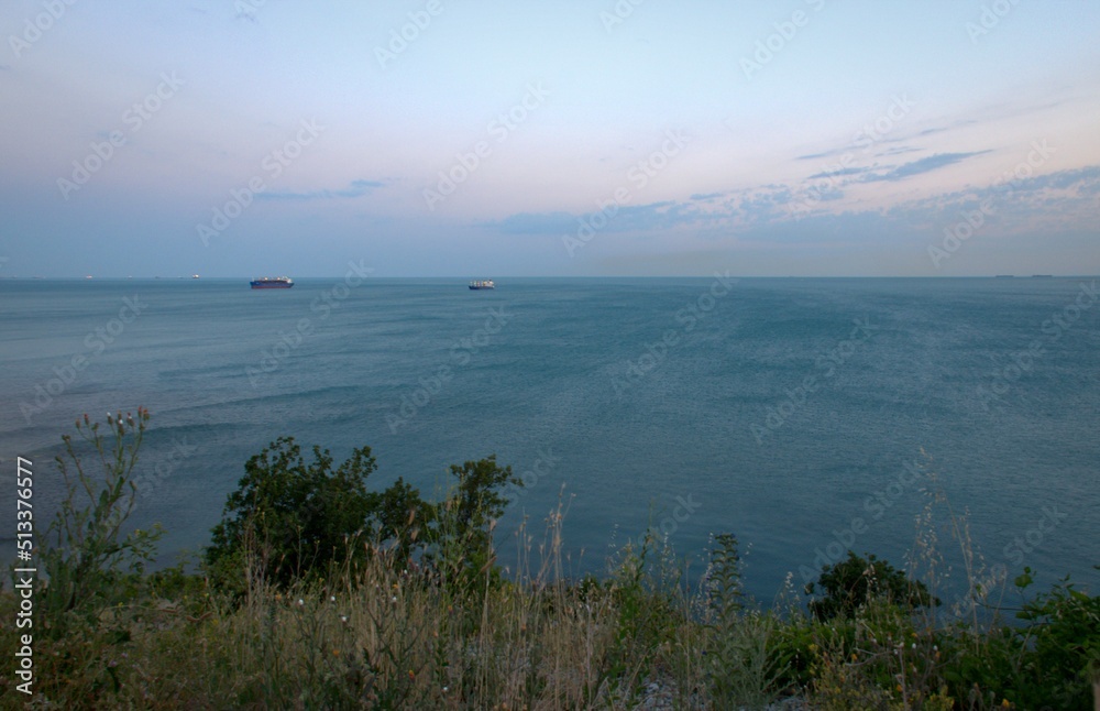 Pink sunset. Summer warm laziness.Panoramic view of the Black Sea. Russia. Blurred background.