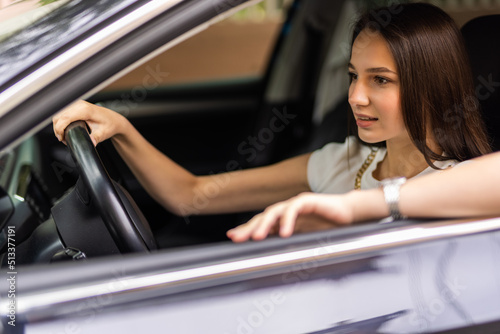 Young happy smiling woman driving her car.