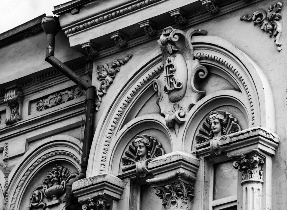 Cartouche on an old house. Aphrodite mascaron on the old facade