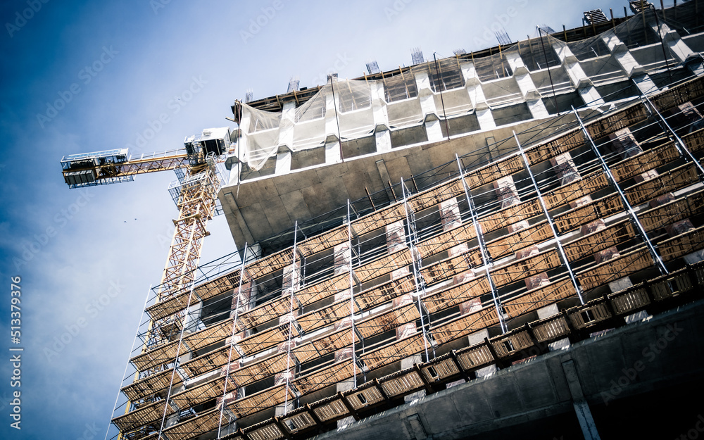 Scaffolding and crane. High-rise building construction