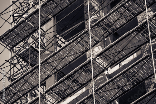 Scaffolding on the building. House construction, monochrome