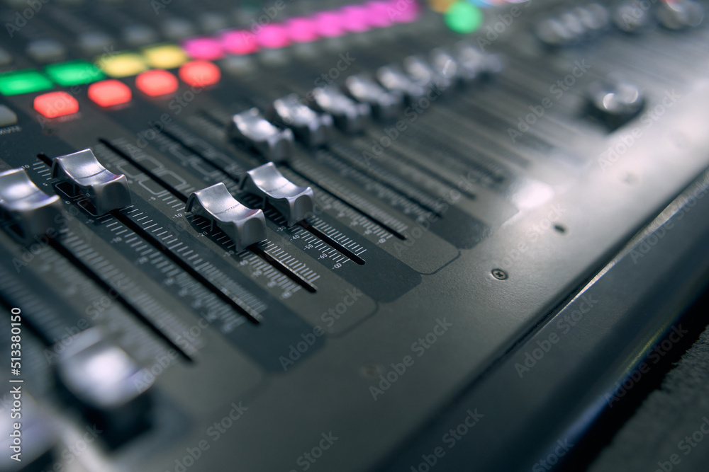 Professional audio mixing console. ​Mixer. Pro audio mixing board faders and knobs. Static shot of multi-track music recording equipment faders and sliders. 