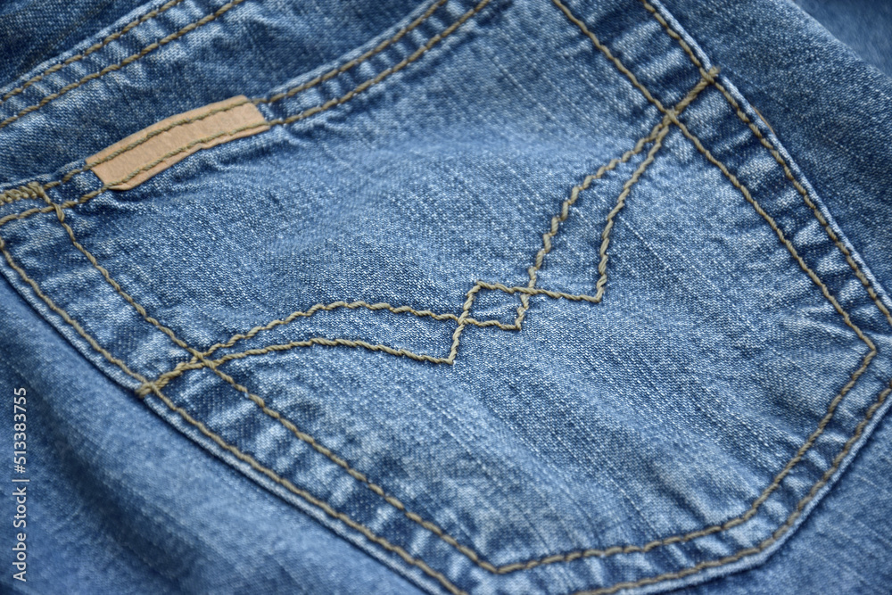 Fototapeta premium Lots of jeans pants in a stack. Denim background.