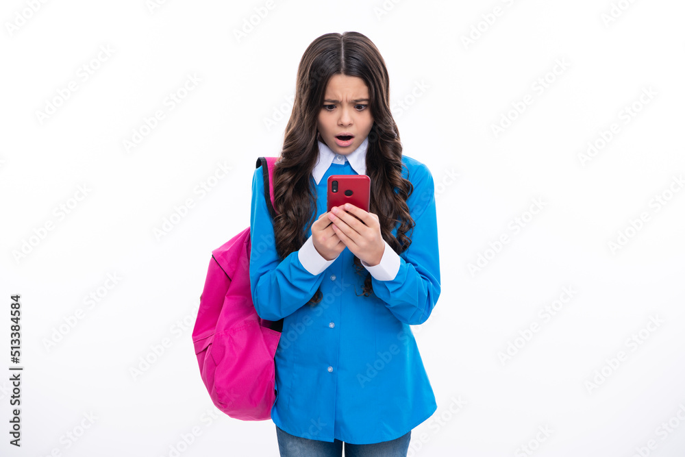 Excited face. Teen school student girl hold backpack use mobile cell phone on white background. Amazed expression, cheerful and glad. Excited face. Teen school student girl hold backpack use mobile cell phone on white background. Amazed expression, cheerful and glad.