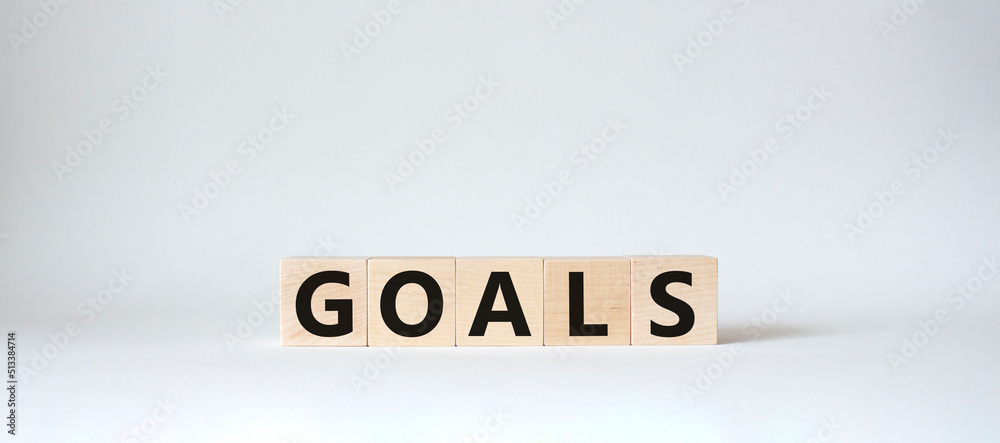 Goals symbol. Concept word Goals on wooden cubes. Beautiful white background. Business and Goals concept. Copy space. Goals symbol. Concept word Goals on wooden cubes. Beautiful white background. Business and Goals concept. Copy space.