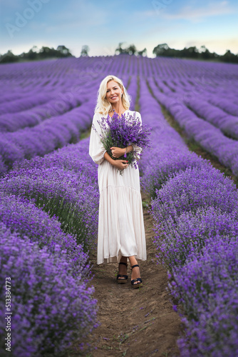 Beautiful girl on the lavender field.Beautiful blonde woman in the lavender field on sunset.