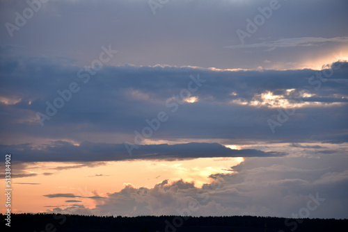 Fototapeta Naklejka Na Ścianę i Meble -  Evening clouds are blue pink and the forest horizon