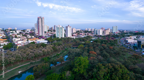 Indaiatuba Ecological Park. Beautiful park in the city center, with lake and beautiful trees and houses. Aerial view © Pedro
