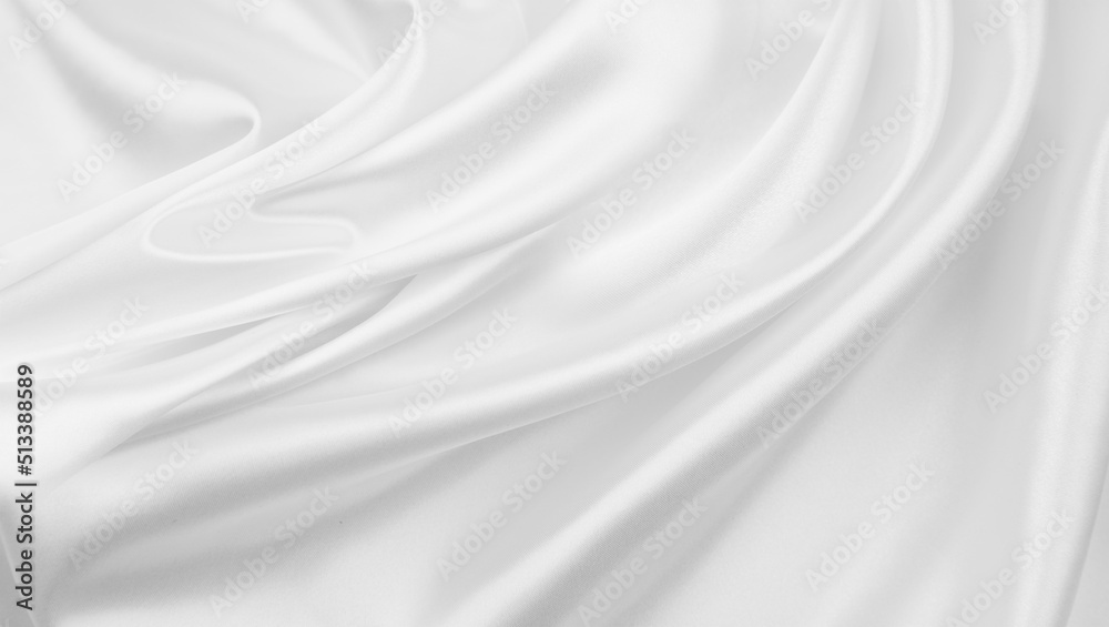 Close-up of rippled white silk fabric texture background
