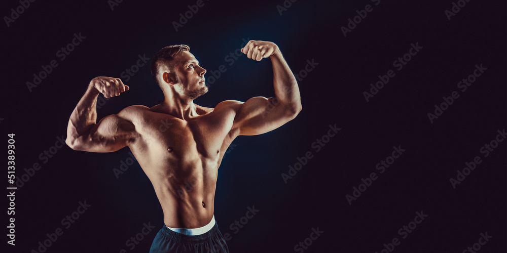 bodybuilder posing. Beautiful sporty guy male power. Fitness muscular body. Isolated on black background bodybuilder posing. Beautiful sporty guy male power. Fitness muscular body. Isolated on black background