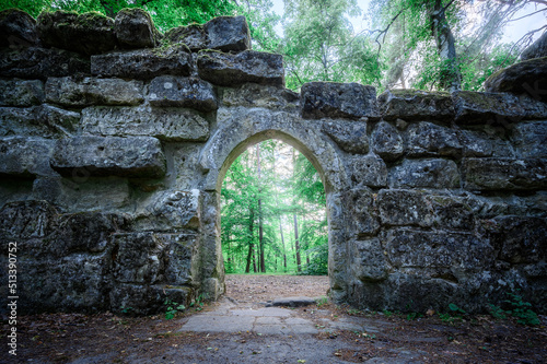 Fototapet ancient archway with late springtime forest in background