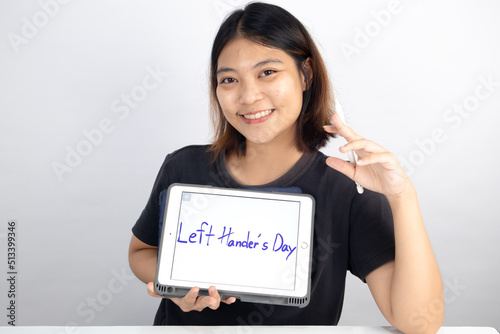 Asian woman with Left Hander's Day concept photo