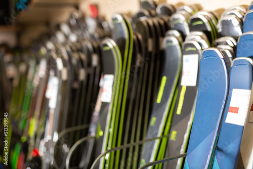 Large selection of skis for sale in the sports equipment store at mountain ski resort