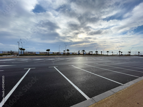 Empty parking lot with sunrise sky in the background