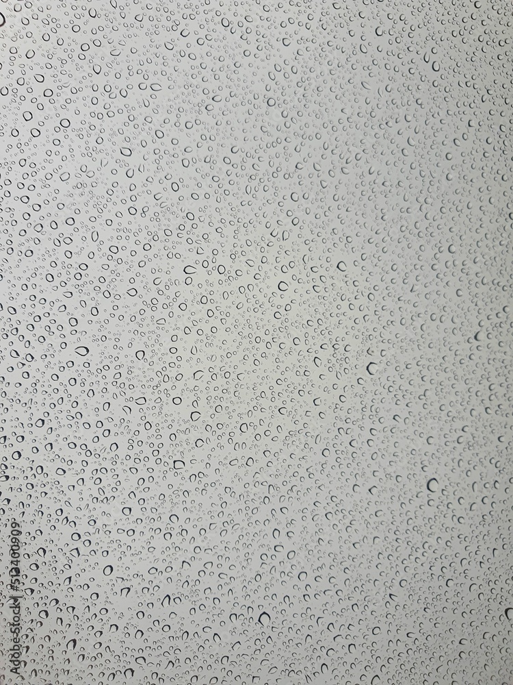 Raindrops on the top window (glass).
Water drops on background.