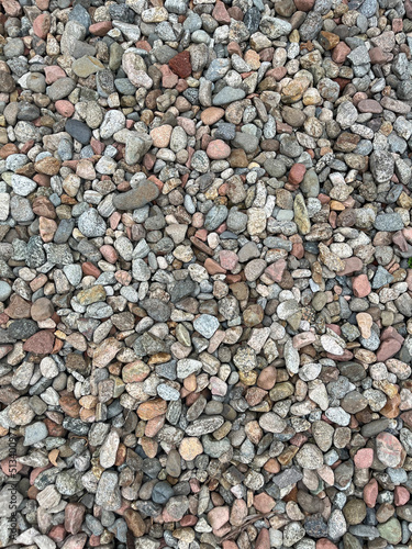 Small stone texture for background. High quality photo. Rocks on a walk by the water.