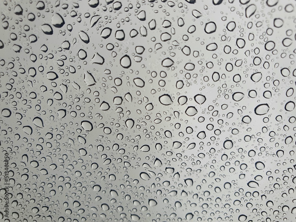 Raindrops on the top window (glass).
Water drops on background.