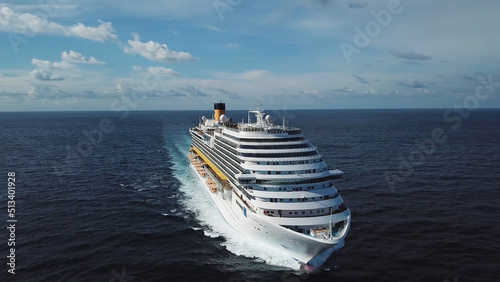 Side view of modern ocean liner in open sea, luxury vacation concept. Stock. Aerial of picturesque seascape with a cruise ship sailing across the sea.
