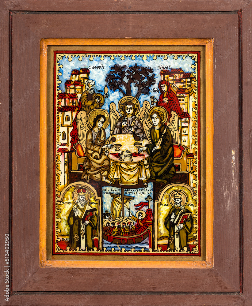 Framed icon painted on reverse glass in the naive orthodox style of Eastern Europe depicting the Holy Trinity.