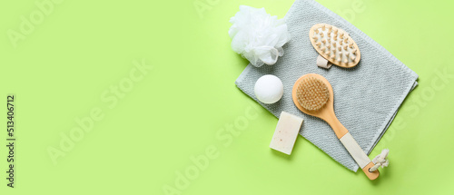 Composition with bath supplies on green background with space for text