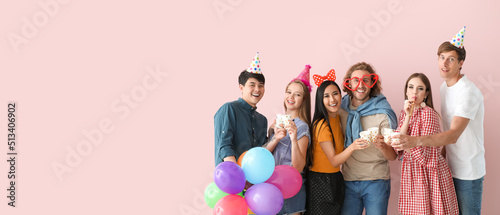 Group of friends celebrating Birthday on pink background with space for text
