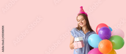 Happy woman with birthday gifts and balloons on pink background with space for text