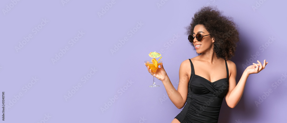Beautiful African-American woman in bikini and with cocktail on lilac background with space for text Beautiful African-American woman in bikini and with cocktail on lilac background with space for text