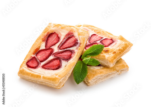 Strawberry puff pastries with mint leaves on white background