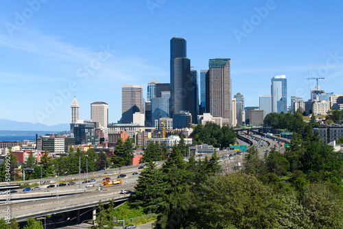Cityscape view of the Seattle skyline with Interstate 5 on a sunny summer morning under a blue sky in June 2022