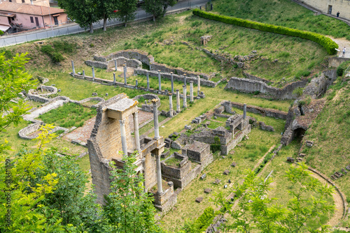 The ancient ruins of the Roman Theatre or Teatro Romano outside the city walls of the Tuscan hilltop medieval town of Volterra, Italy.