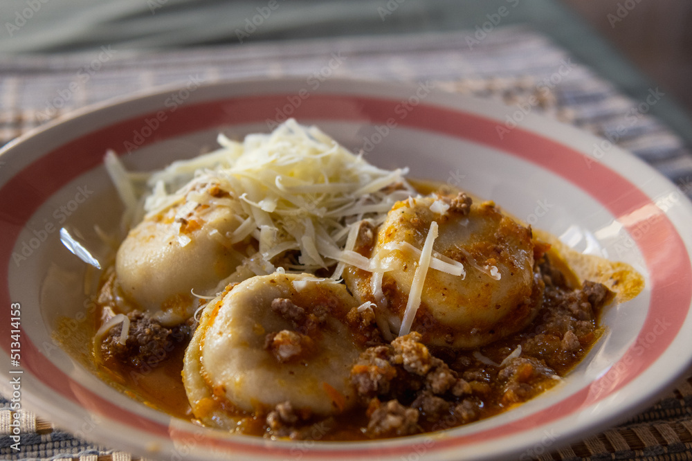 dish of sorrentinos with bolognese sauce dish of sorrentinos with bolognese sauce