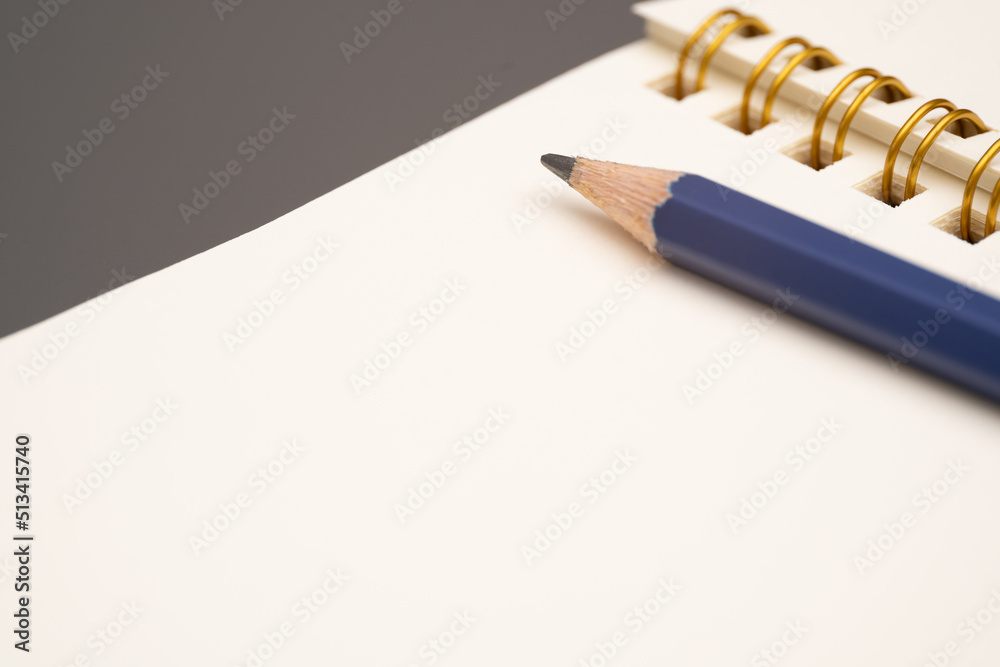 Notebook with a pencil. open spiral blank notebook with pencil on white desk background Notebook with a pencil. open spiral blank notebook with pencil on white desk background