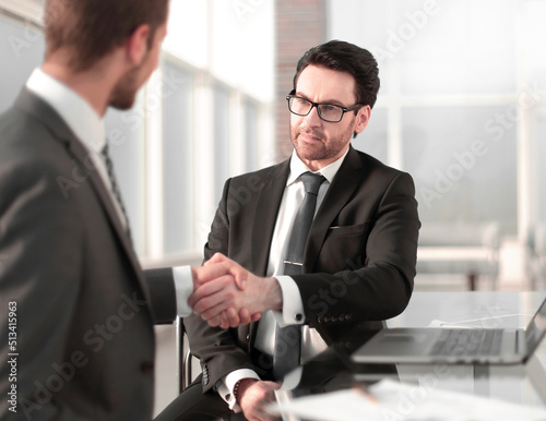 business people shaking hands over a Desk